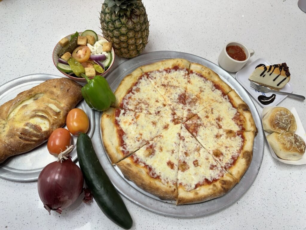 Cheese Pizza, Stromboli (ham, pepperoni, and cheese), salad, bread, and cheesecake.